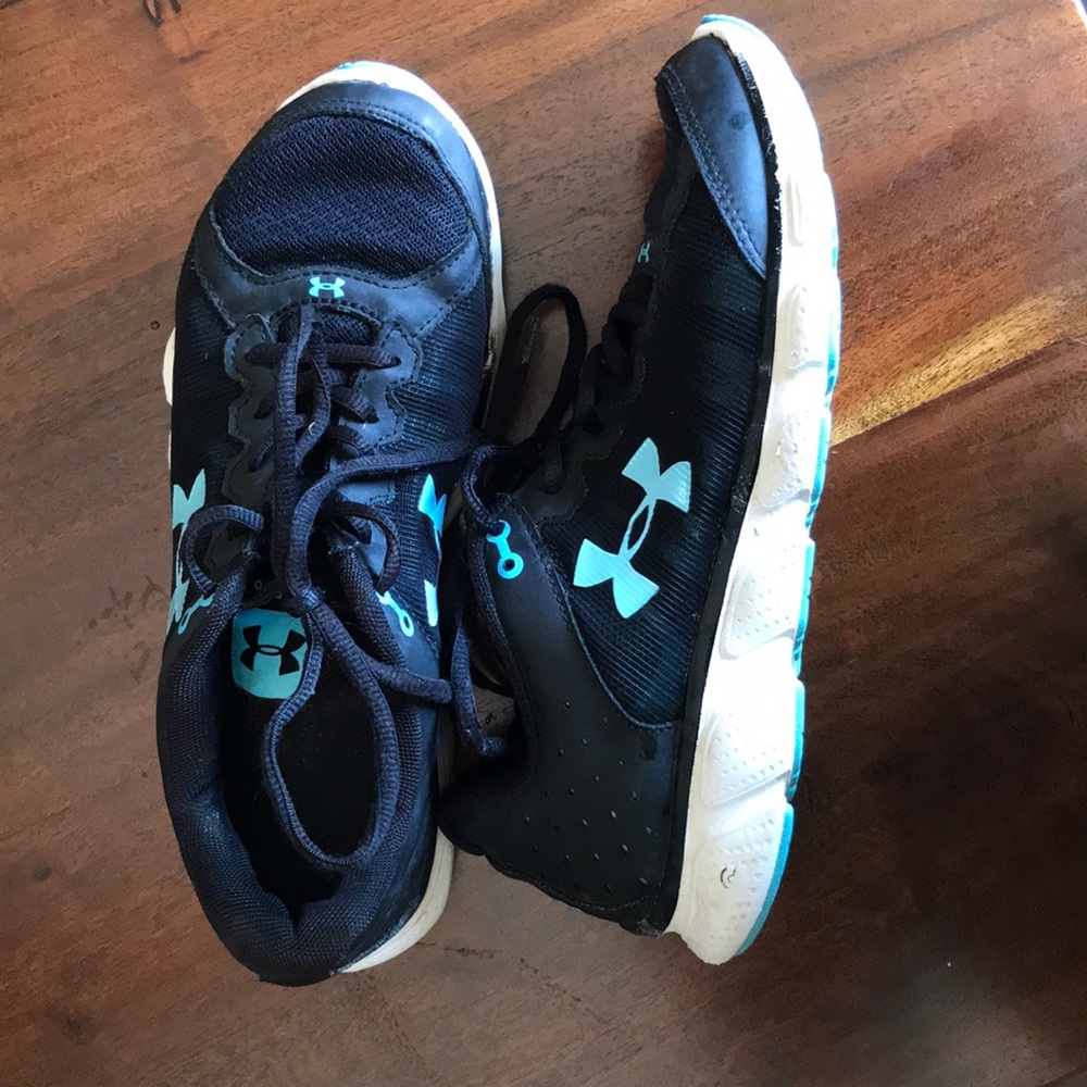 Under Armour assert 6 tennis shoes black and teal.